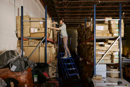 An employee works on luggage in a factory, illustrating how a Colorado manufacturer survived Trump's trade war.