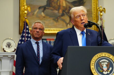 Donald Trump in a courtroom, looking at papers, for a news quiz.
