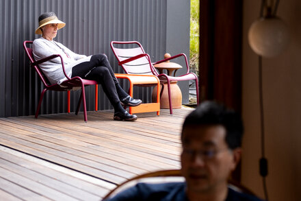 A modern Australian house with a unique architectural design, featuring sustainable elements for temperature regulation, set against a sunny backdrop.