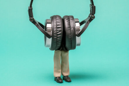 A person looking thoughtful while listening to classical music on headphones, possibly inspired by Beethoven's Symphony No. 5.