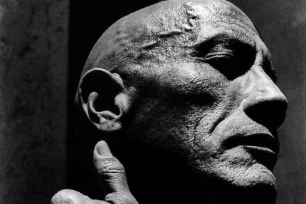 Dwayne 'The Rock' Johnson intensely looking forward, face smudged with dirt or makeup, suggesting a struggle or an athletic endeavor.
