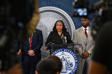 Fani Willis, District Attorney for Fulton County, Georgia, speaking at a podium.