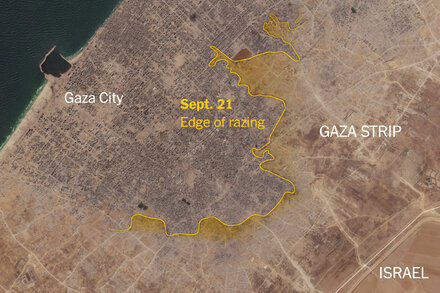 Aerial view of destroyed buildings and rubble in Gaza City, showing widespread devastation.