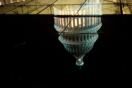 US Capitol Building at dusk with a government shutdown infographic overlaid