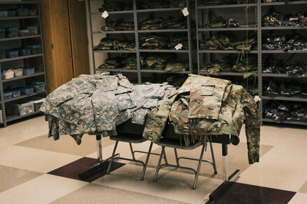 A close-up of a document or report cover, possibly with a title related to 'sexual misconduct' or 'JROTC', resting on a table.