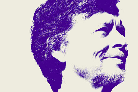 Ken Burns, a renowned documentary filmmaker, stands pensively in a historical setting, perhaps a colonial-era building or battlefield, with a thoughtful expression.