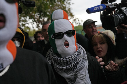 Móglaí Bap of the Irish hip-hop group Kneecap stands outside a courthouse.