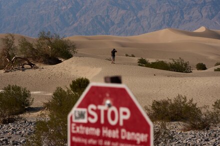 Empty national park entrance with a 'Closed' sign due to government shutdown, illustrating the plea from former superintendents.