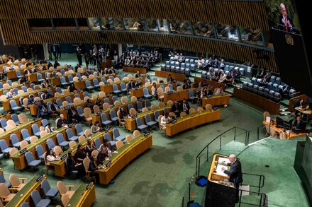 Benjamin Netanyahu speaks at a podium to a largely empty United Nations General Assembly hall.