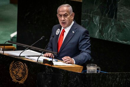 Benjamin Netanyahu delivers a speech at the United Nations General Assembly, with the U.N. logo visible behind him.