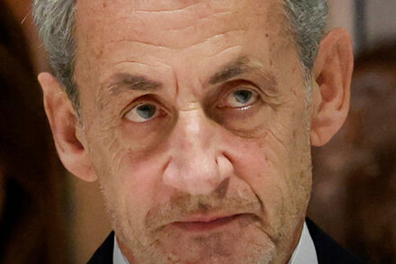 Former French President Nicolas Sarkozy, looking serious, in a headshot.