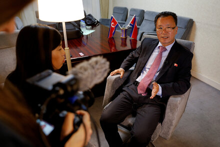 A North Korean delegation attends the United Nations General Assembly, with delegates seated at a table displaying a 'Democratic People's Republic of Korea' nameplate.