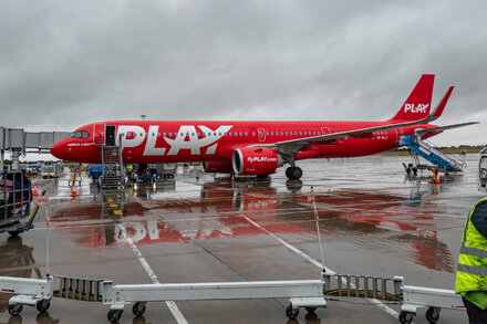 Empty gate at an airport with a 'Play Icelandic' sign, symbolizing the airline's sudden folding and stranded passengers.