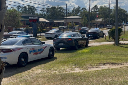 Police officers gather near an elementary school after a shooting incident in Valdosta, Georgia.
