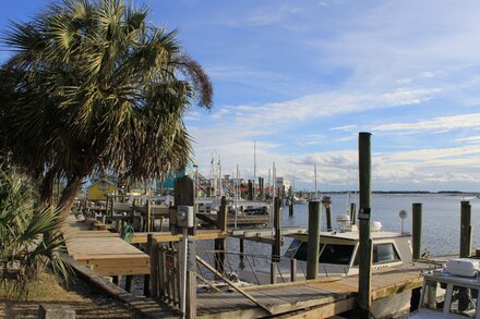 A feature image depicting a riverside bar, possibly with an emergency presence or a quiet, somber scene, related to a shooting incident in North Carolina.