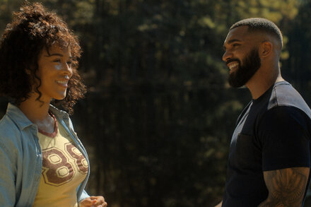 A modern couple, a man and a woman, gaze at each other in a warm, intimate setting, reflecting a contemporary take on the biblical story of Ruth and Boaz.
