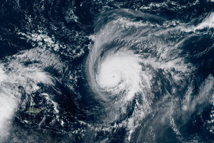 Satellite map showing a tropical system over the Atlantic Ocean, approaching the southeastern U.S. coastline. Clouds are visible, indicating a storm.