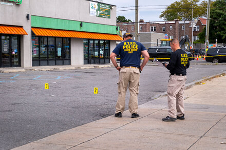 A somber news photograph shows a young person's face with a sorrowful expression, possibly a family member or friend, reflecting on the tragedy of a teen shot and killed. The background is blurred, focusing attention on the emotional impact.