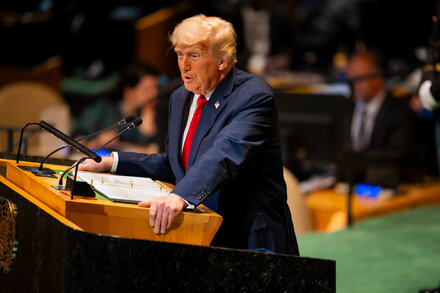 Donald Trump with a gavel, symbolizing his power to impose tariffs, with a blurred image of the Supreme Court in the background, representing its limited reach.