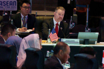 Donald Trump with Asian leaders during a trade meeting, discussing new tariffs and the ongoing trade war.