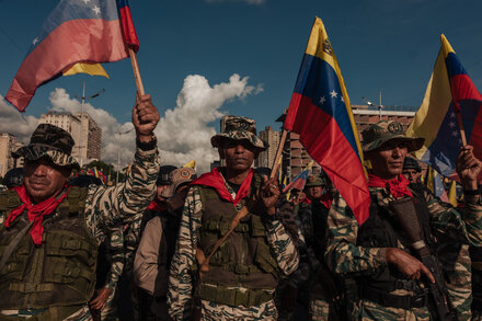 Protesters in Caracas, Venezuela, march against government policies, displaying banners with anti-regime slogans.