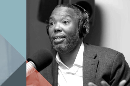 Ta-Nehisi Coates with a serious expression, looking directly at the camera. He is wearing glasses and a dark shirt.