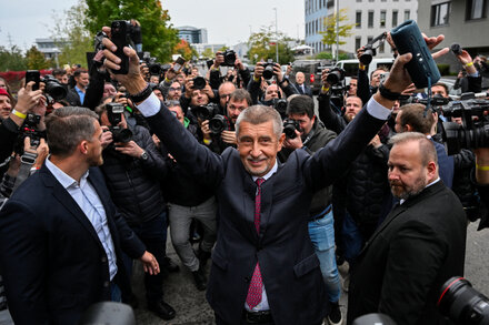 Andrej Babiš, former Czech Prime Minister, addressing supporters after election results, with Czech flag visible in background.