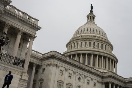 Empty U.S. House of Representatives chamber with House Speaker's dais visible, conveying the absence of lawmakers during a critical political moment.