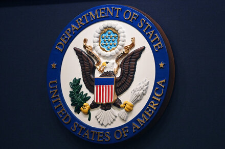 A diplomat in a suit stands in a formal setting. The image is a file photo, not directly related to the specific firing but used to represent a diplomat.