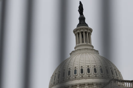 A government building with 'CLOSED' sign due to federal shutdown, illustrating the article's theme.