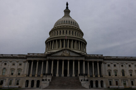 Empty US Capitol Building steps with a 'Closed' sign, symbolizing a government shutdown and its impact on public services.