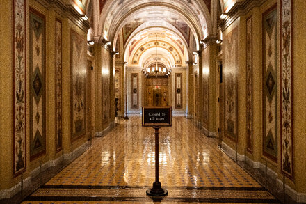 Empty US Capitol Building steps with a 'Closed' sign, symbolizing a government shutdown and its impact.