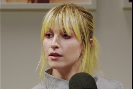 Hayley Williams, lead singer of Paramore, looking thoughtful with her signature red-orange hair