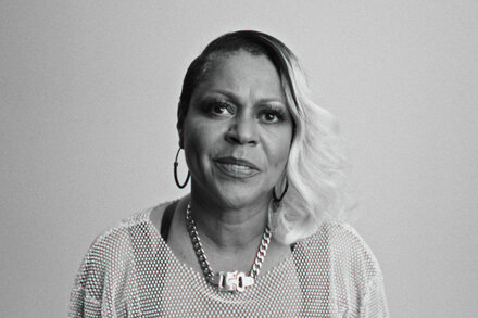 Portrait of a house music icon with a vibrant background, symbolizing energizing power.