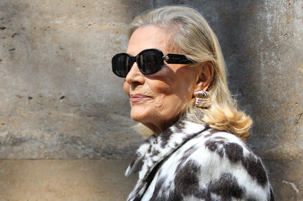 A stylish Milanese woman walking down a city street, dressed in a chic, tailored outfit, exuding effortless elegance.