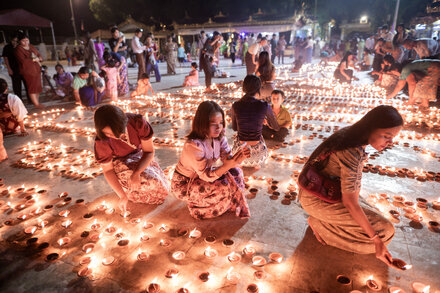 A destroyed crowd of people and buildings in Myanmar after a paraglider bomb attack during a Buddhist festival, with debris scattered everywhere.