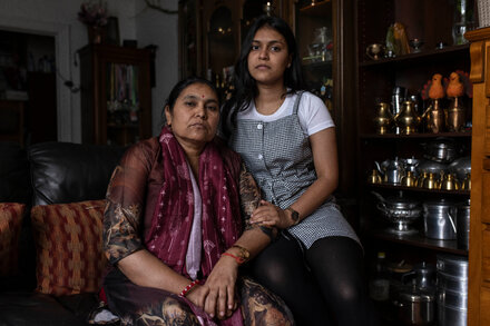 Family members holding photos of a Nepali student hostage by Hamas, appealing for his release.