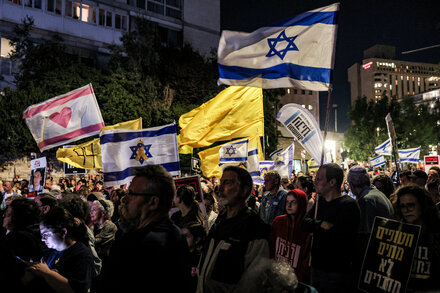 Benjamin Netanyahu speaks at a podium, with an Israeli flag visible behind him, during a press conference.