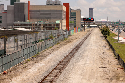 A man in an orange jumpsuit is escorted by police officers in Atlanta, Georgia. This is the last of ten escapees from a New Orleans jail.