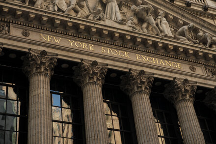 New York Stock Exchange building with Polymarket logo overlaid, representing the partnership and mainstream adoption of prediction markets.