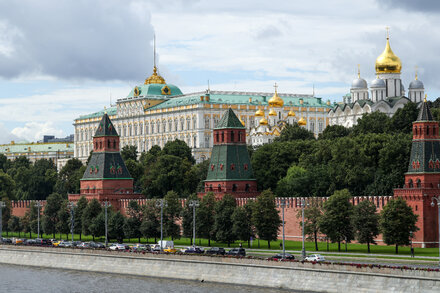 A Russian flag with a silhouette of a soldier in the foreground, symbolizing Russia's military spending and economic strain.