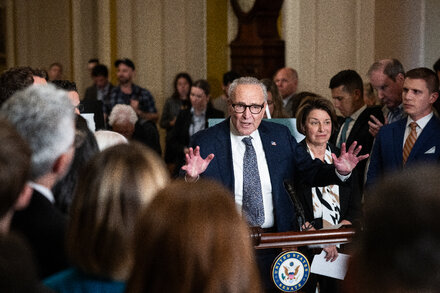 A visual representation of political polarization in the U.S. Senate, showing two distinct groups of senators with a chasm between them, symbolizing the gridlock and difficulty in reaching bipartisan agreements that often lead to government shutdowns.
