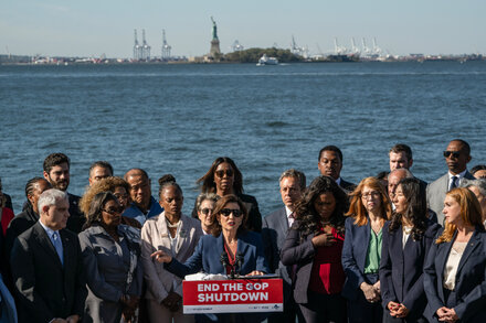Statue of Liberty's torch against a dark sky, symbolizing a potential government shutdown.