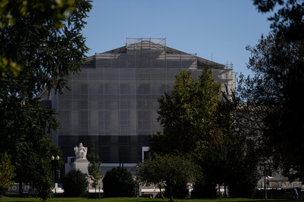 A group of lawyers and plaintiffs stand outside the Supreme Court building, possibly discussing the case related to conversion therapy. The Supreme Court's facade is visible in the background, suggesting a legal context.