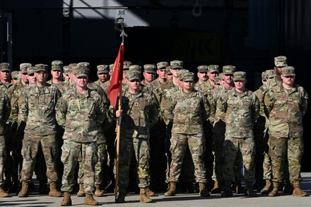 A U.S. Army soldier stands guard during a training exercise. The image highlights the presence of U.S. military personnel.