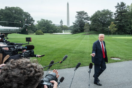 Empty White House gates and a 'Closed' sign during a government shutdown, symbolizing maximized pain and punishment.