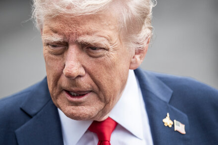 Donald Trump speaks at a podium with the White House seal, addressing reporters on health care and government shutdown strategy.