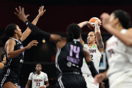 WNBA Player Dribbling on Court - Increased Attention Article Feature